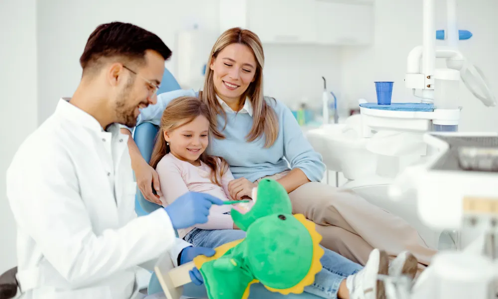 Pediatric dentist examining a child during a dental checkup